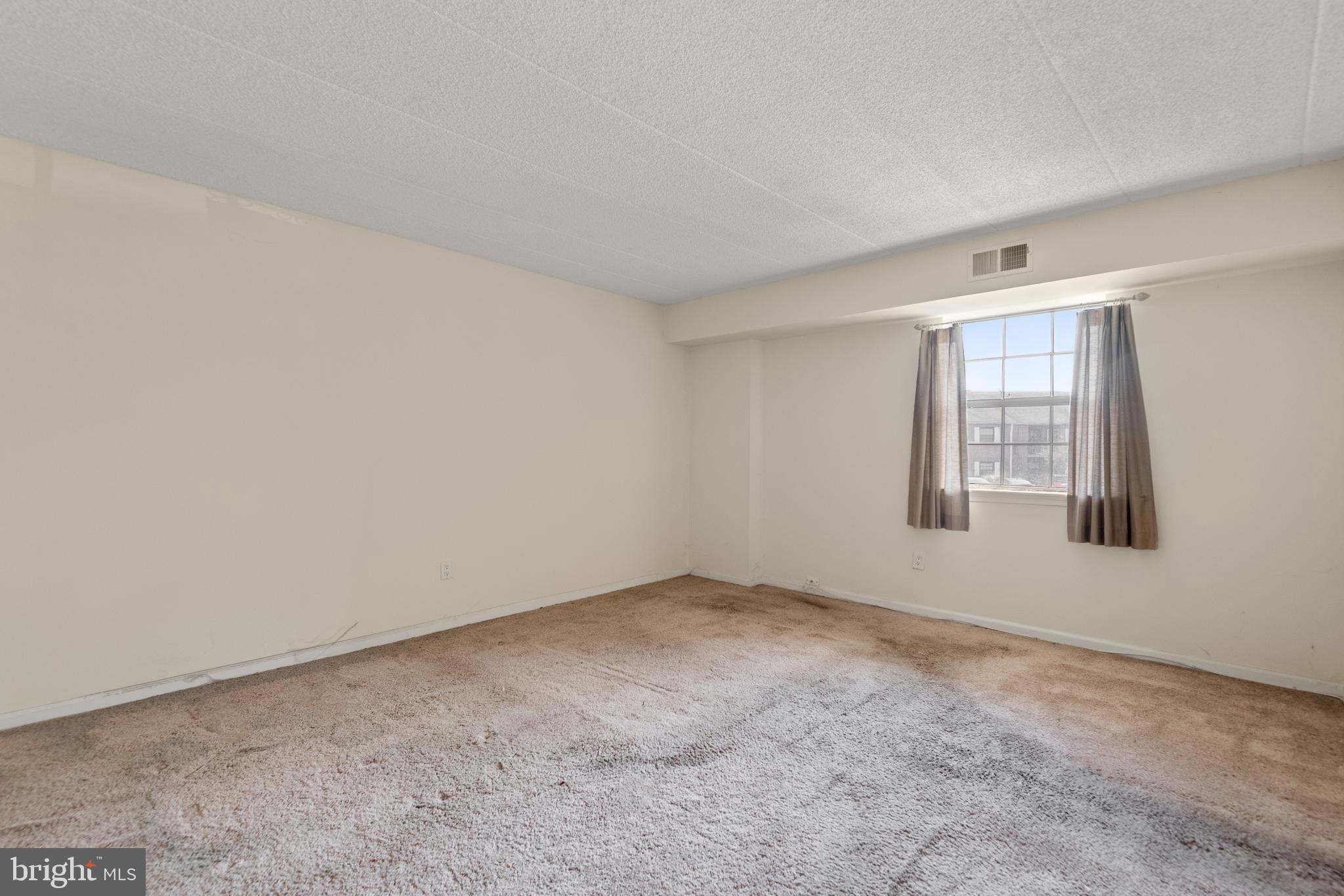 130 Riversedge Drive, Unit CONDO 130 Norristown, PA 19403 - Photo 13 of 20 a view of an empty room with a window