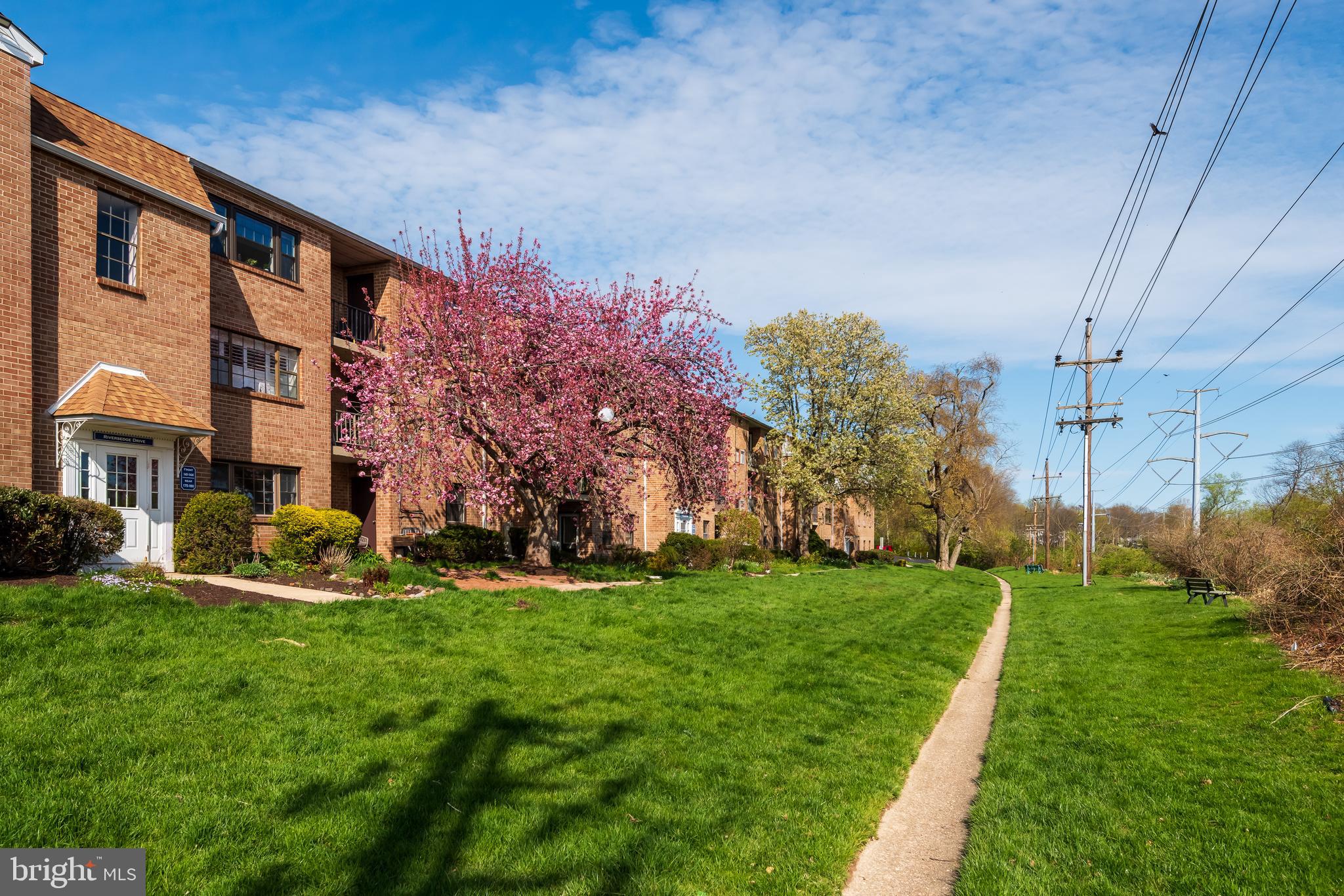 130 Riversedge Drive, Unit CONDO 130 Norristown, PA 19403 - Photo 19 of 20 a front view of a building with a yard