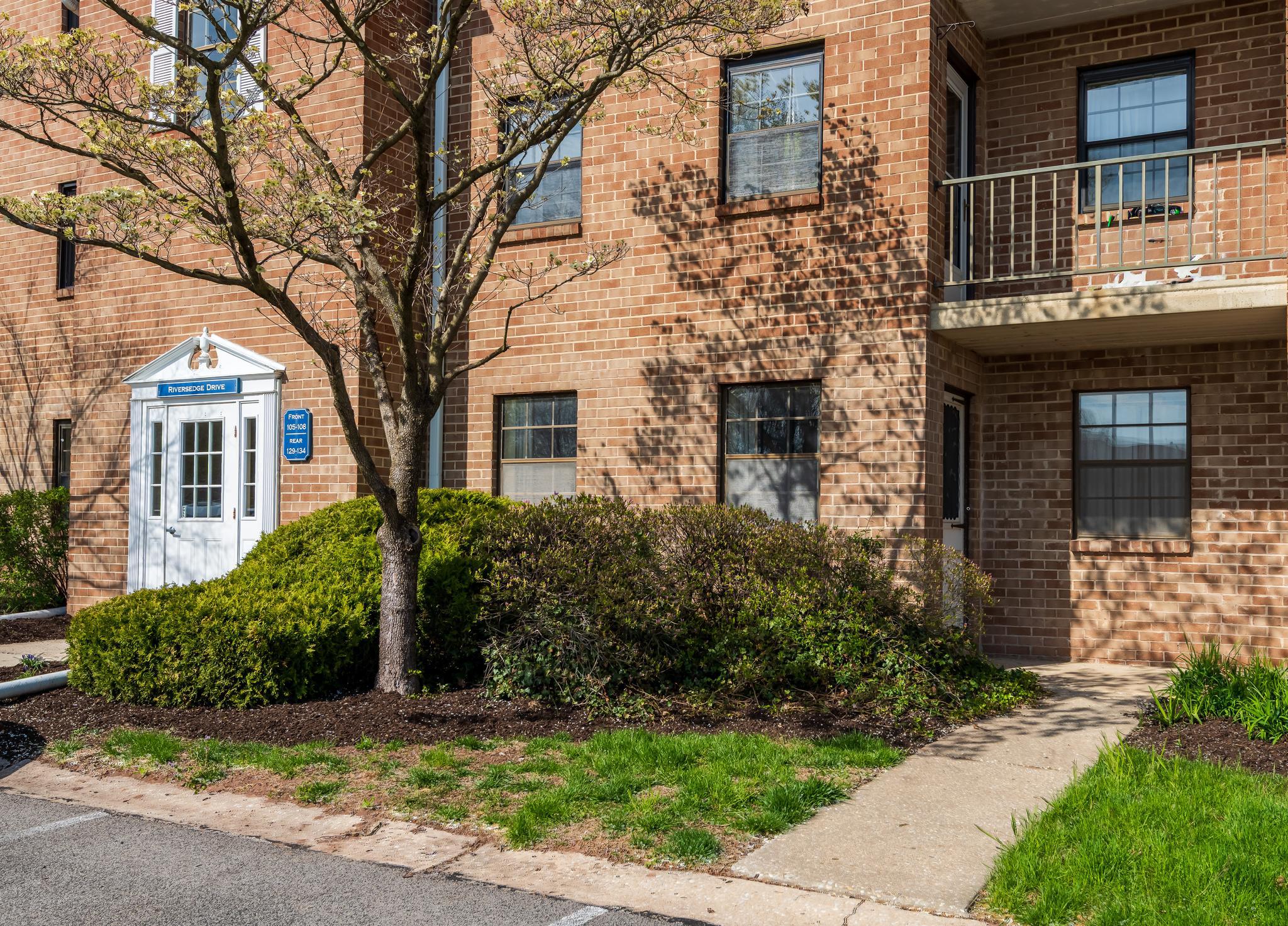 130 Riversedge Drive, Unit CONDO 130 Norristown, PA 19403 - Photo 3 of 20 a front view of a house with garden