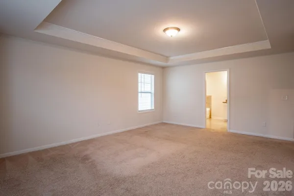 an empty room with a window and a ceiling fan