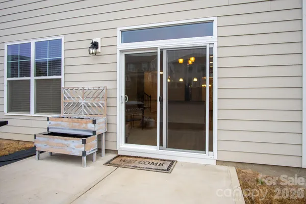 a backyard of a house with barbeque oven and outdoor seating