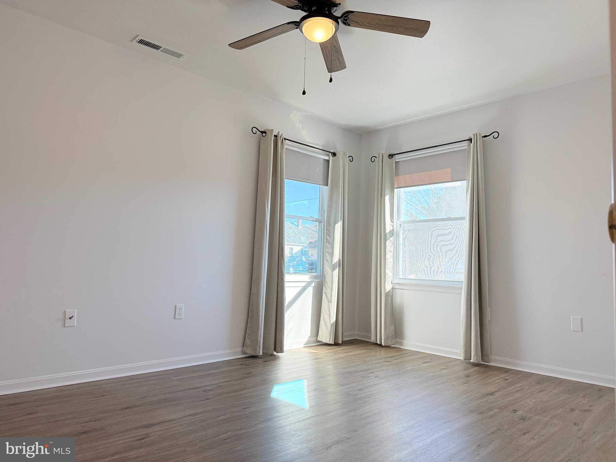 400 Franklin Street Georgetown, DE 19947 - Photo 6 of 10 an empty room with wooden floor and windows