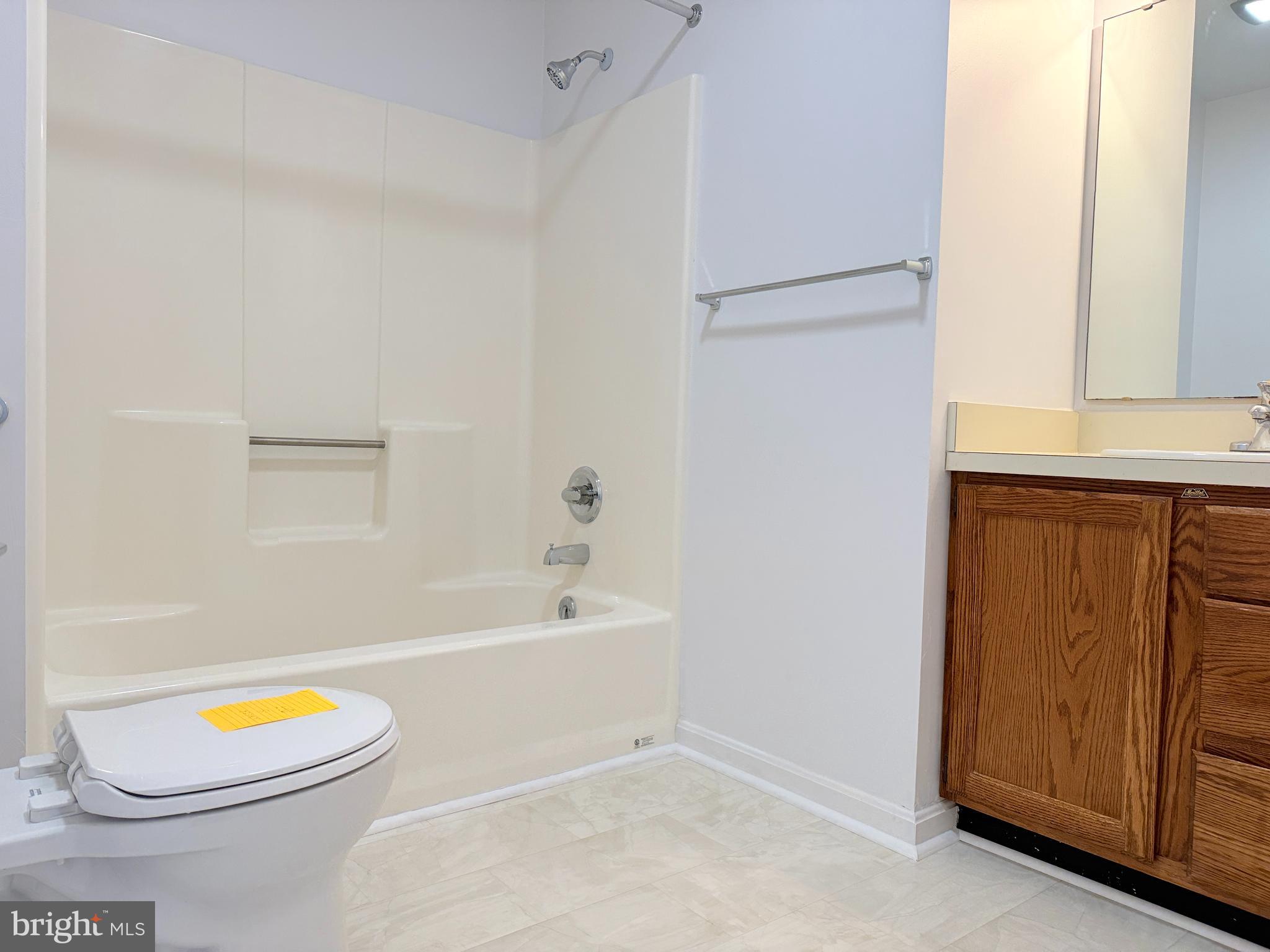 400 Franklin Street Georgetown, DE 19947 - Photo 7 of 10 a bathroom with a sink a toilet and bathtub