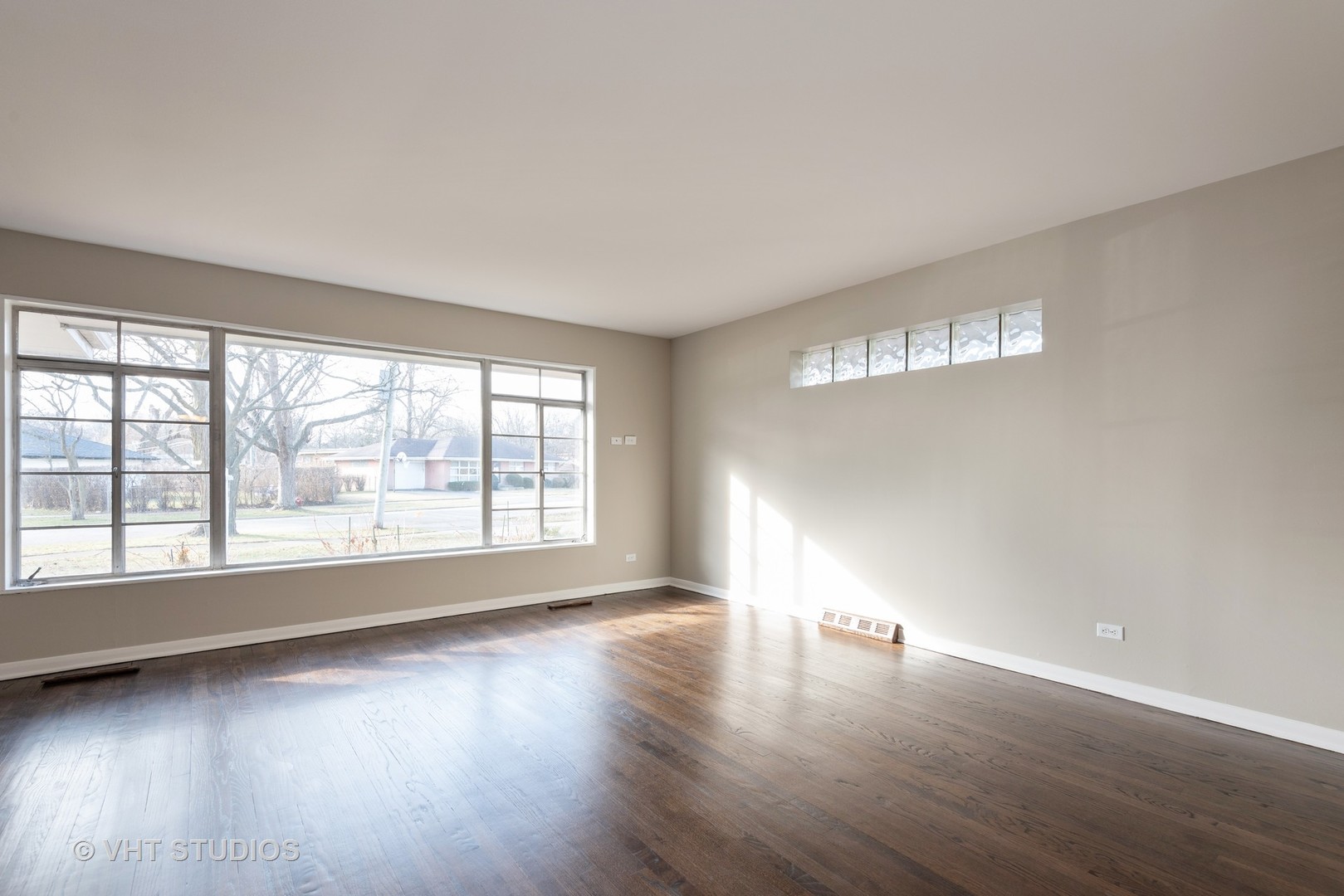 263 Riverside Drive Northfield, IL 60093 - Photo 2 of 17 an empty room with wooden floor and windows