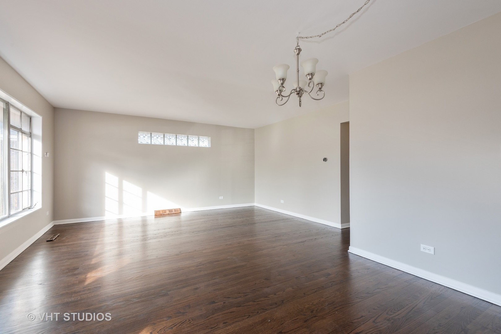 263 Riverside Drive Northfield, IL 60093 - Photo 3 of 17 wooden floor in an empty room with a window
