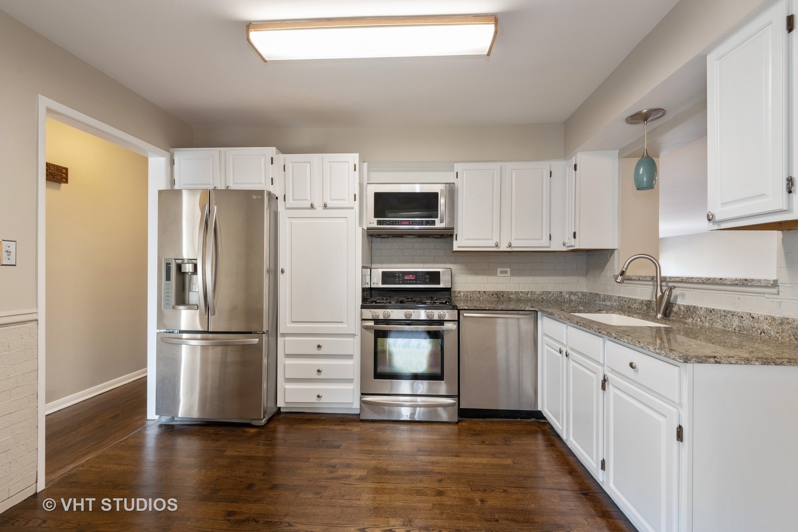 263 Riverside Drive Northfield, IL 60093 - Photo 4 of 17 a kitchen with stainless steel appliances granite countertop a refrigerator and a stove top oven