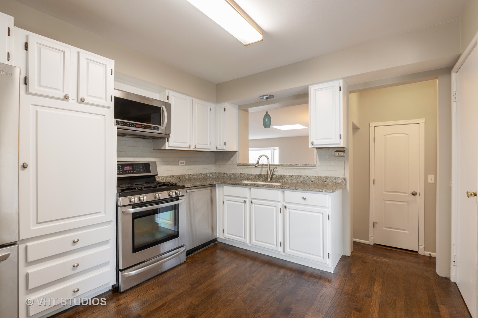 263 Riverside Drive Northfield, IL 60093 - Photo 5 of 17 a kitchen with granite countertop white cabinets and appliances