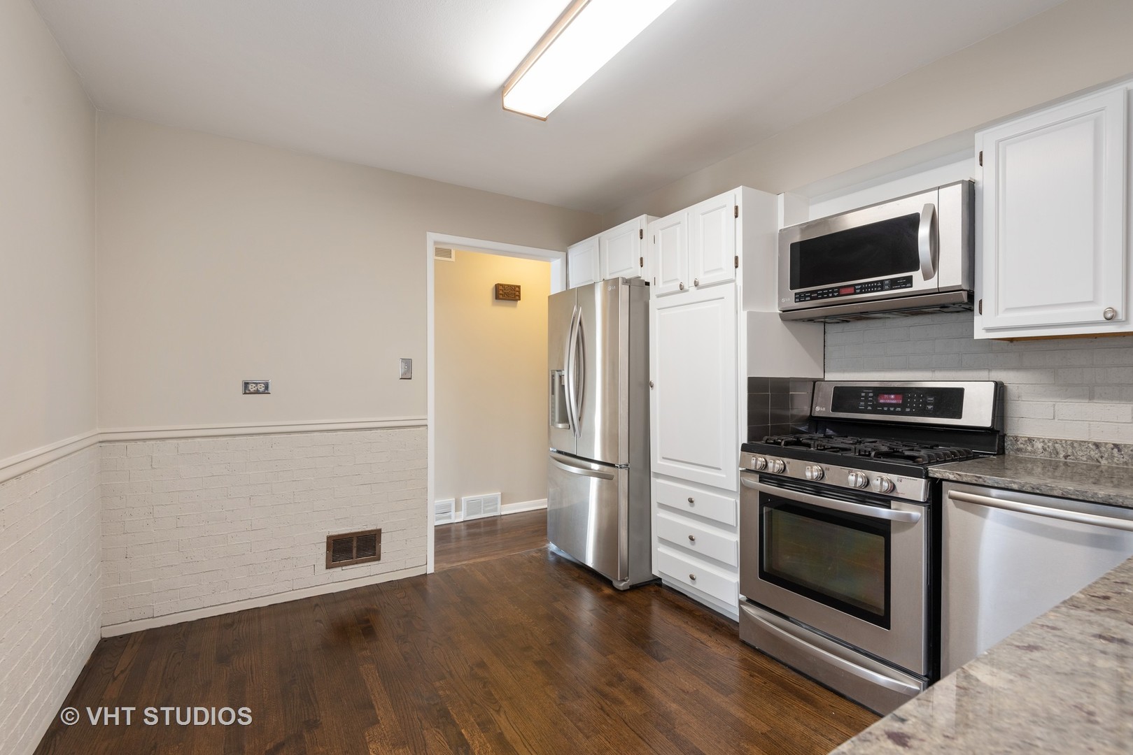 263 Riverside Drive Northfield, IL 60093 - Photo 6 of 17 a kitchen with stainless steel appliances a stove a microwave and a refrigerator