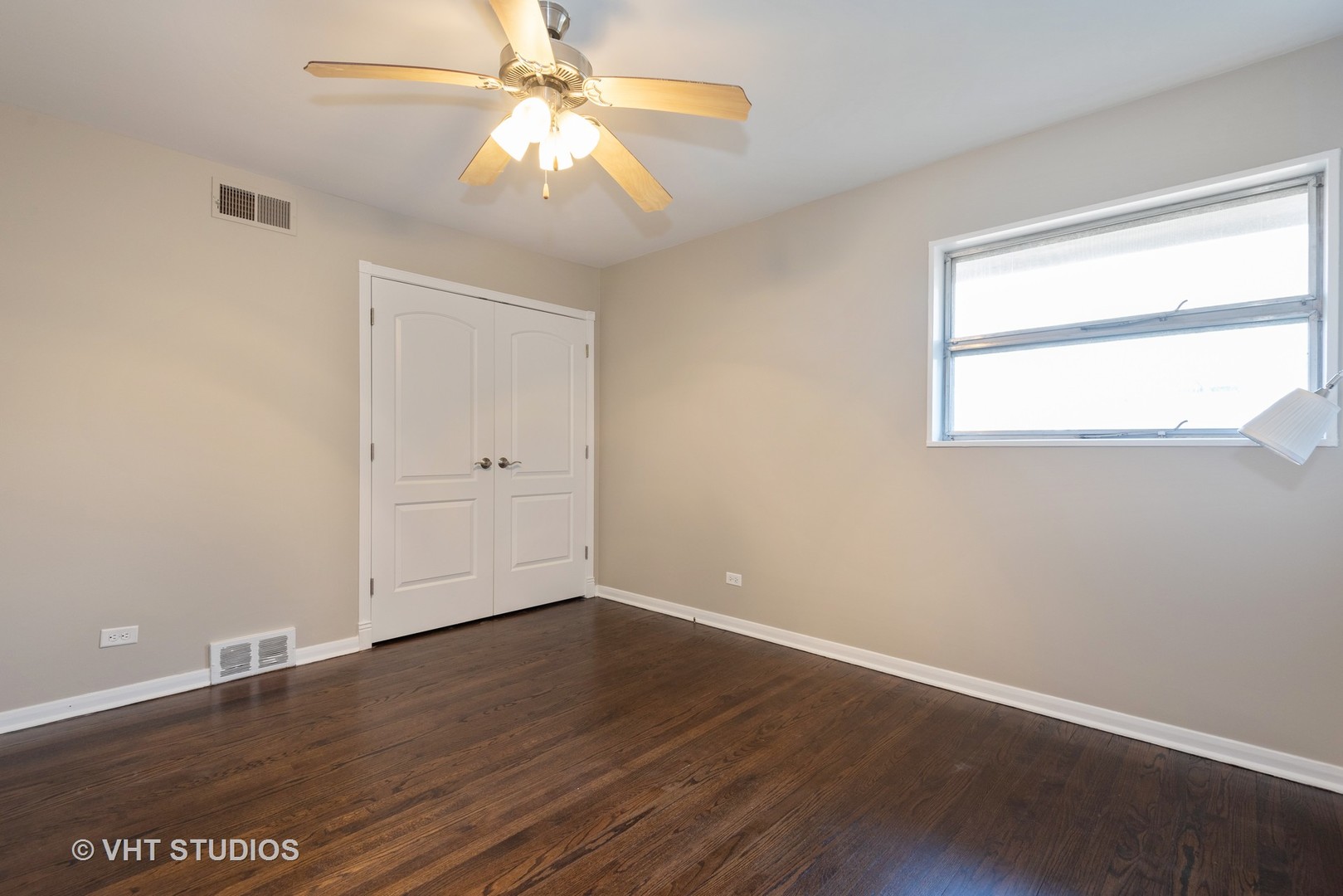 263 Riverside Drive Northfield, IL 60093 - Photo 9 of 17 wooden floor in an empty room with a window