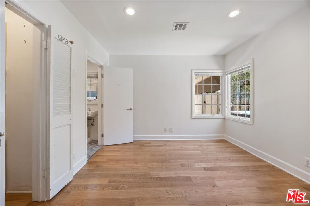 14041 Roblar Road Sherman Oaks, CA 91423 - Photo 26 of 47 wooden floor in an empty room with a window