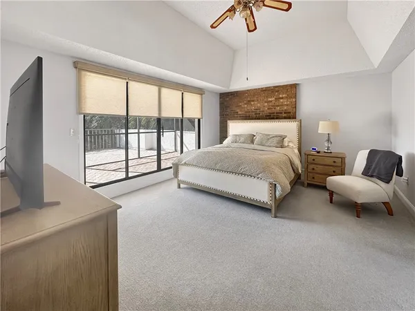 a bedroom with a bed and a large window