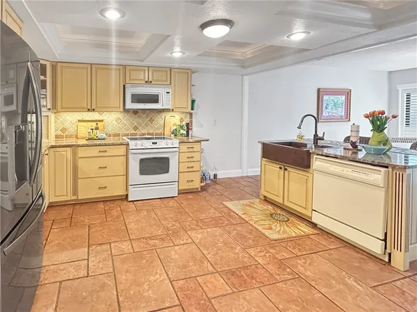 a kitchen with stainless steel appliances granite countertop a sink and cabinets