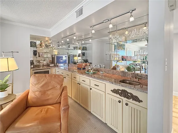 a kitchen with stainless steel appliances kitchen island granite countertop a table and chairs in it