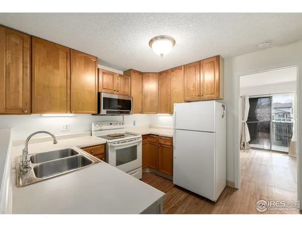 a kitchen with a refrigerator sink and cabinets
