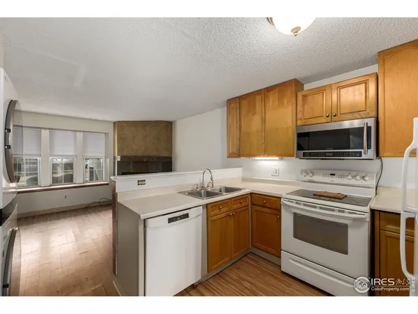 a kitchen with a stove a sink and a microwave