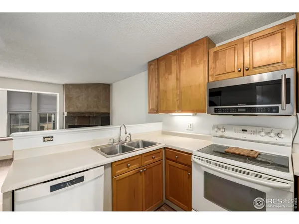a kitchen with stainless steel appliances a stove microwave and sink