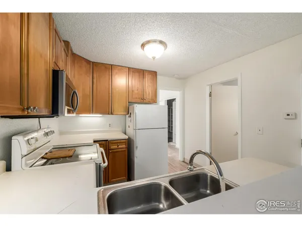 a kitchen with a sink a stove and a refrigerator