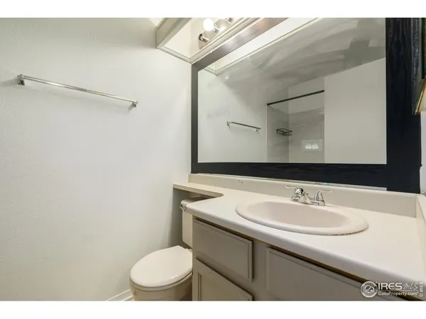 a bathroom with a sink toilet and mirror