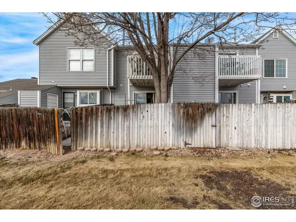 a backyard of a house with a wooden fence