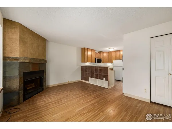 a view of kitchen with granite countertop fireplace and wooden floor