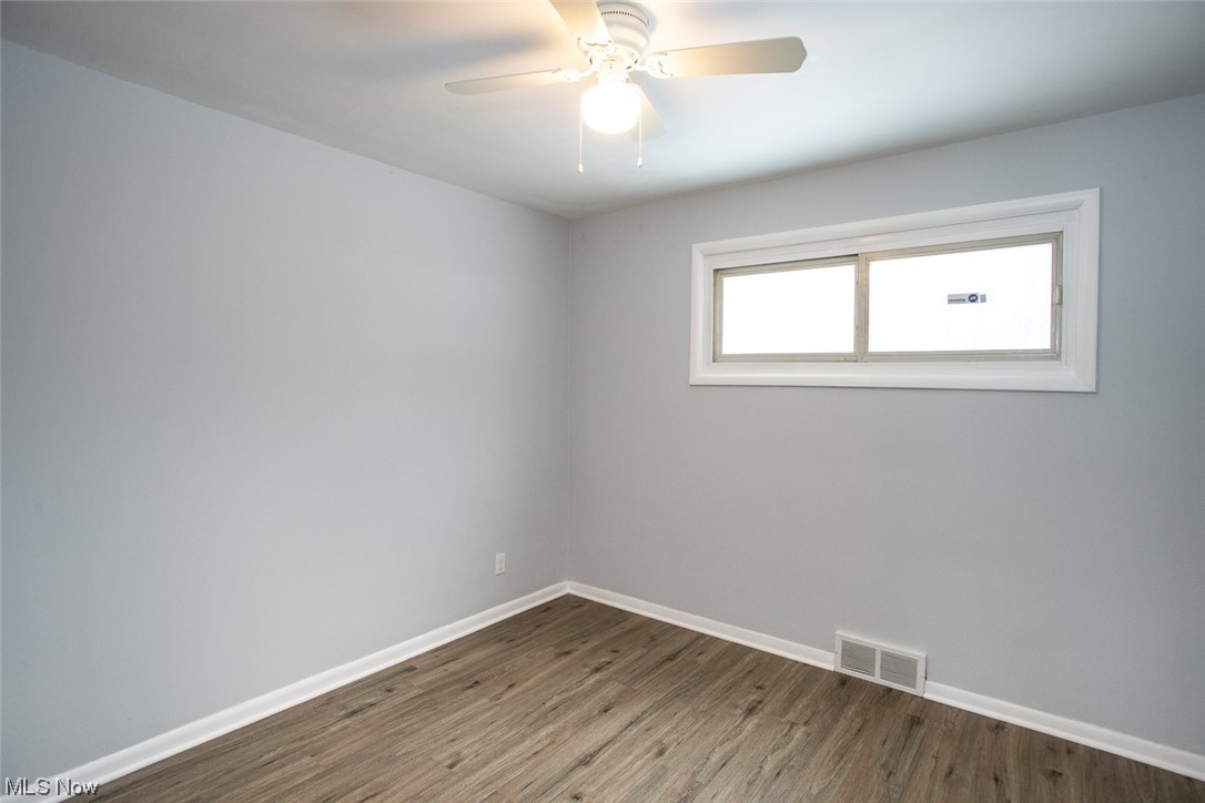 208 Greenvale Road Cleveland, OH 44121 - Photo 21 of 33 Empty room featuring dark wood-type flooring and ceiling fan