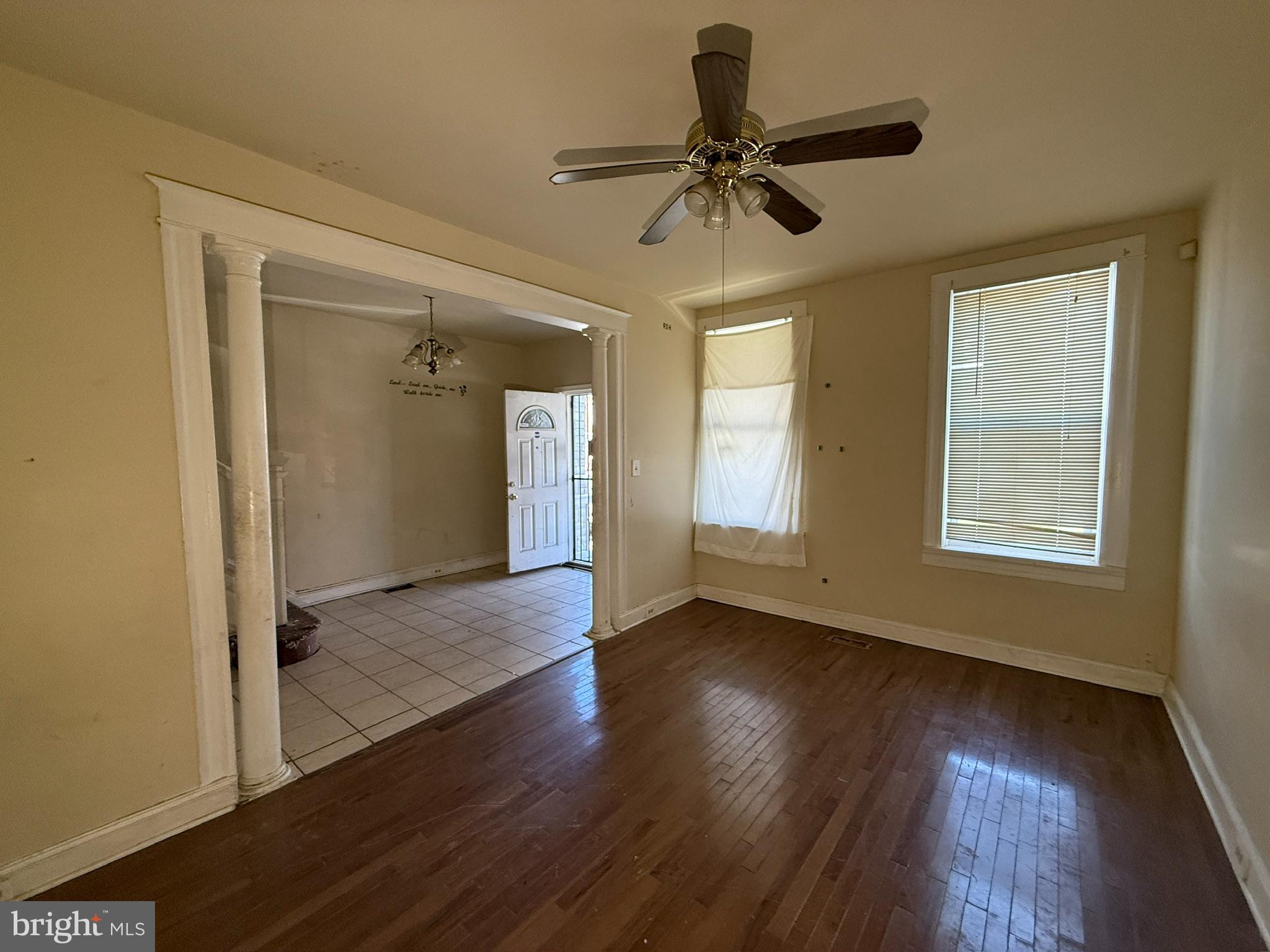 406 Edgewood Street Baltimore, MD 21229 - Photo 2 of 12 a view of empty room with wooden floor and fan