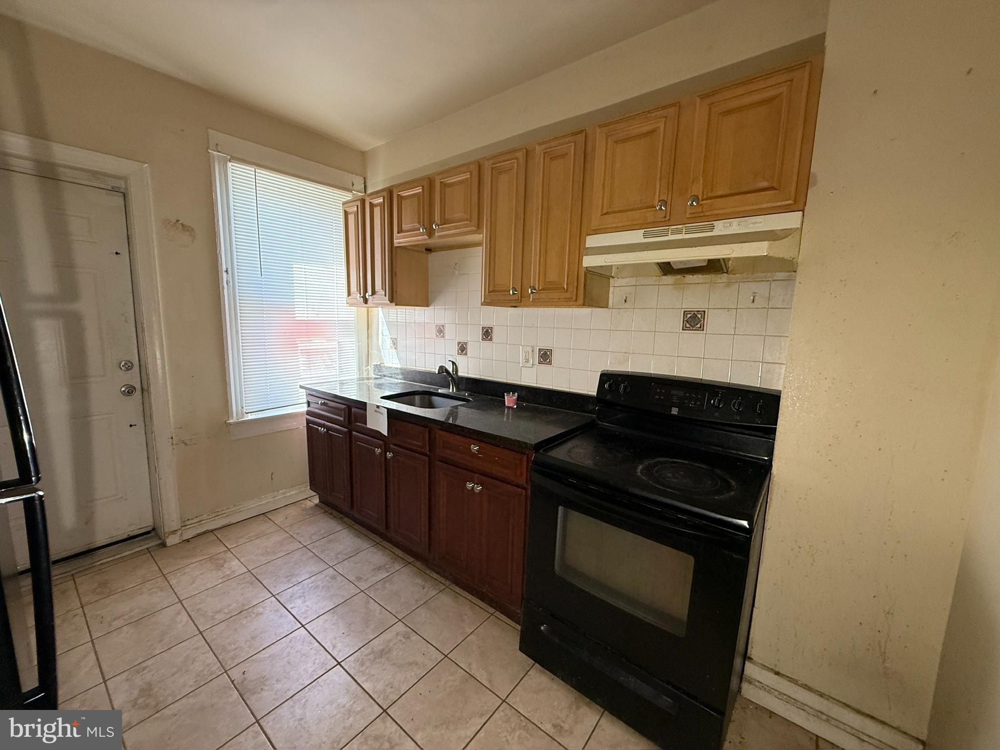 406 Edgewood Street Baltimore, MD 21229 - Photo 3 of 12 a kitchen with a sink stove and cabinets
