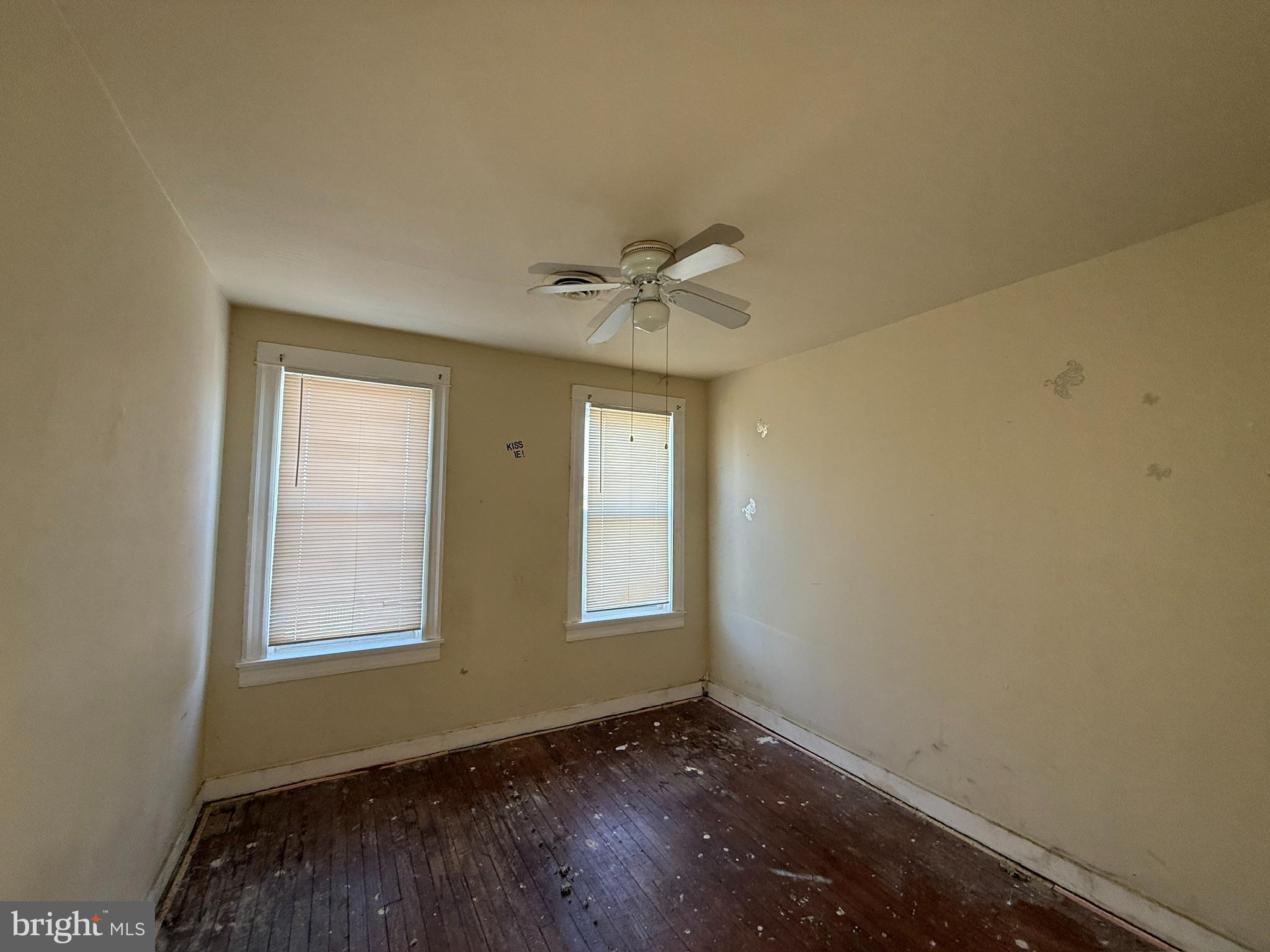 406 Edgewood Street Baltimore, MD 21229 - Photo 8 of 12 a view of an empty room with a window and wooden floor
