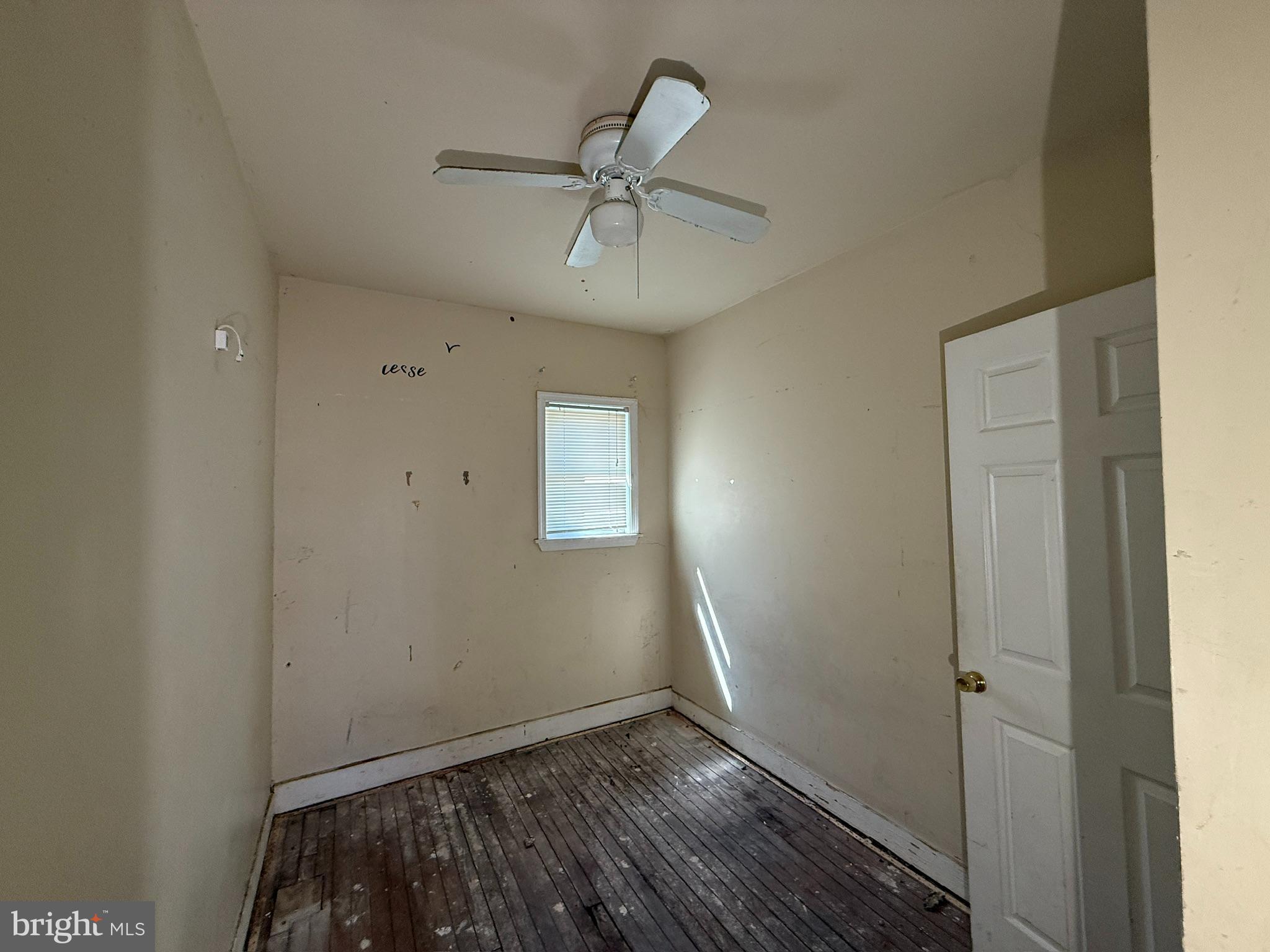 406 Edgewood Street Baltimore, MD 21229 - Photo 10 of 12 wooden floor in an empty room with a window
