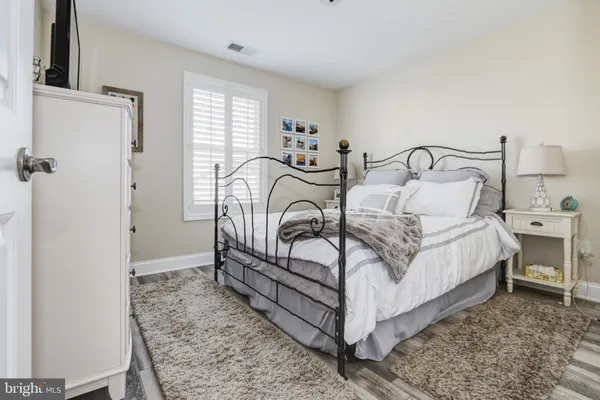 a bedroom with a bed flat screen tv and window