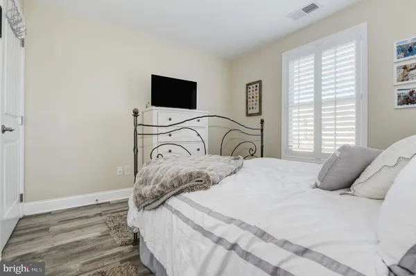 a bedroom with a bed and a television