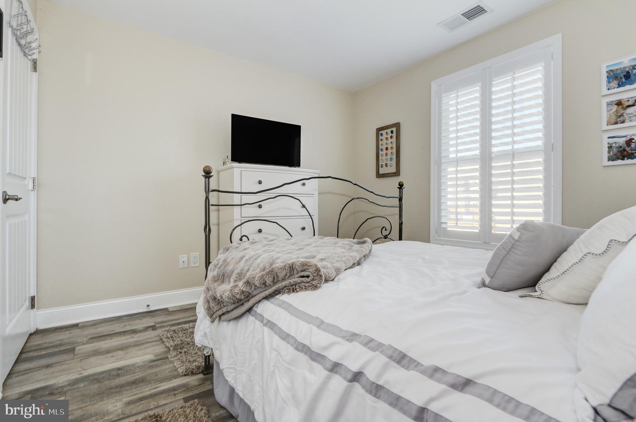 204 10th Street North Brigantine, NJ 08203 - Photo 12 of 88 a bedroom with a bed flat screen tv and window