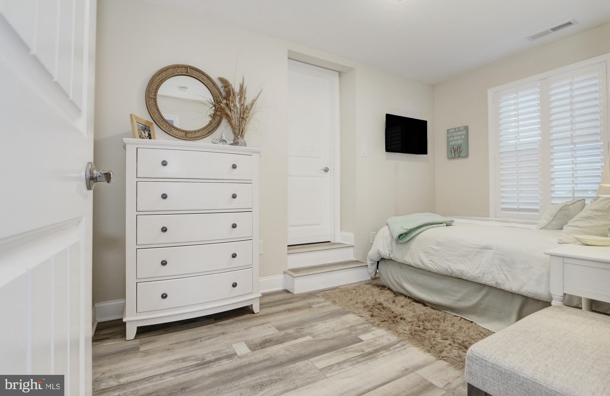 204 10th Street North Brigantine, NJ 08203 - Photo 13 of 88 a bedroom with a bed and a television