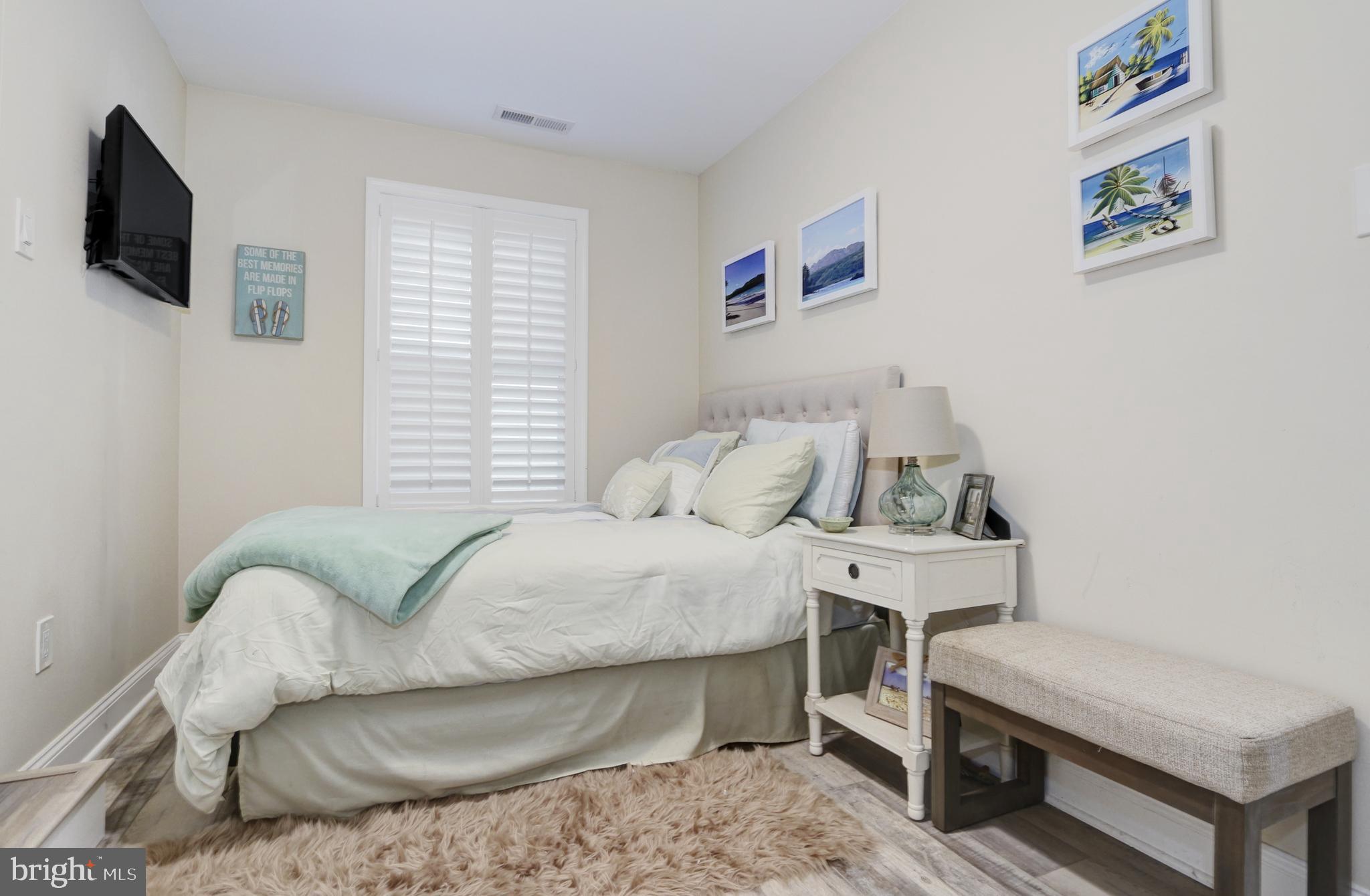 204 10th Street North Brigantine, NJ 08203 - Photo 14 of 88 a bedroom with a bed and a flat screen tv