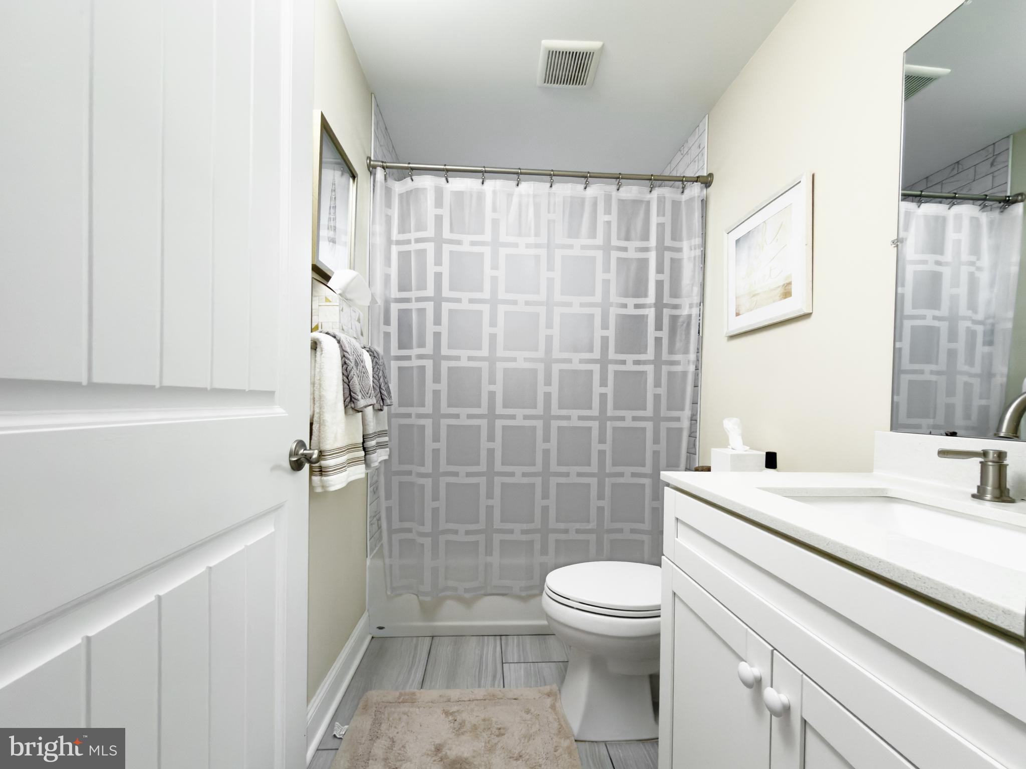 204 10th Street North Brigantine, NJ 08203 - Photo 16 of 88 a bathroom with a sink a toilet and shower
