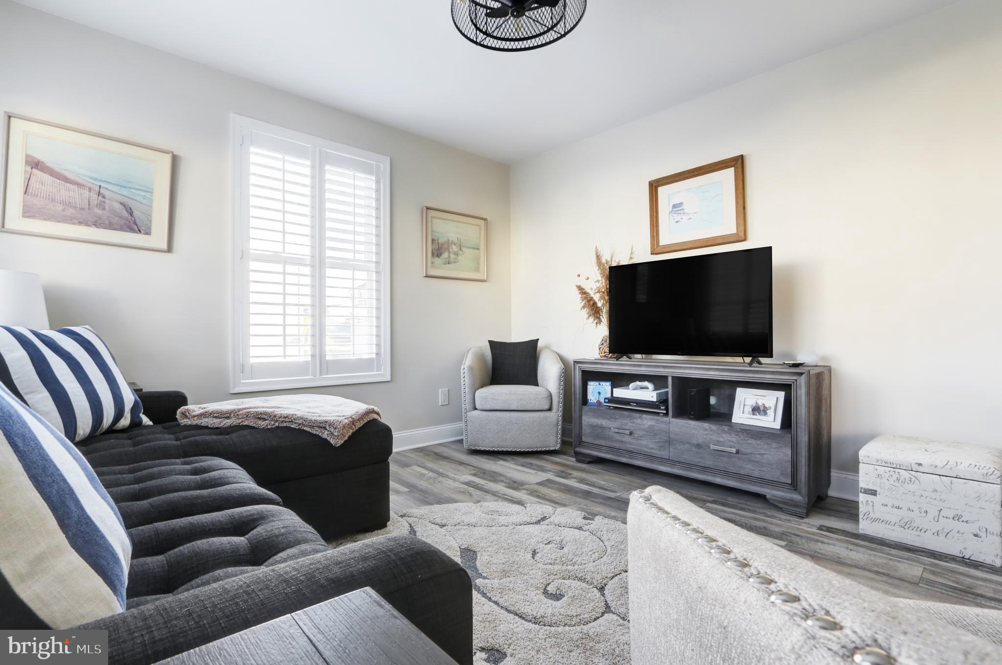 204 10th Street North Brigantine, NJ 08203 - Photo 6 of 88 a living room with furniture and a flat screen tv