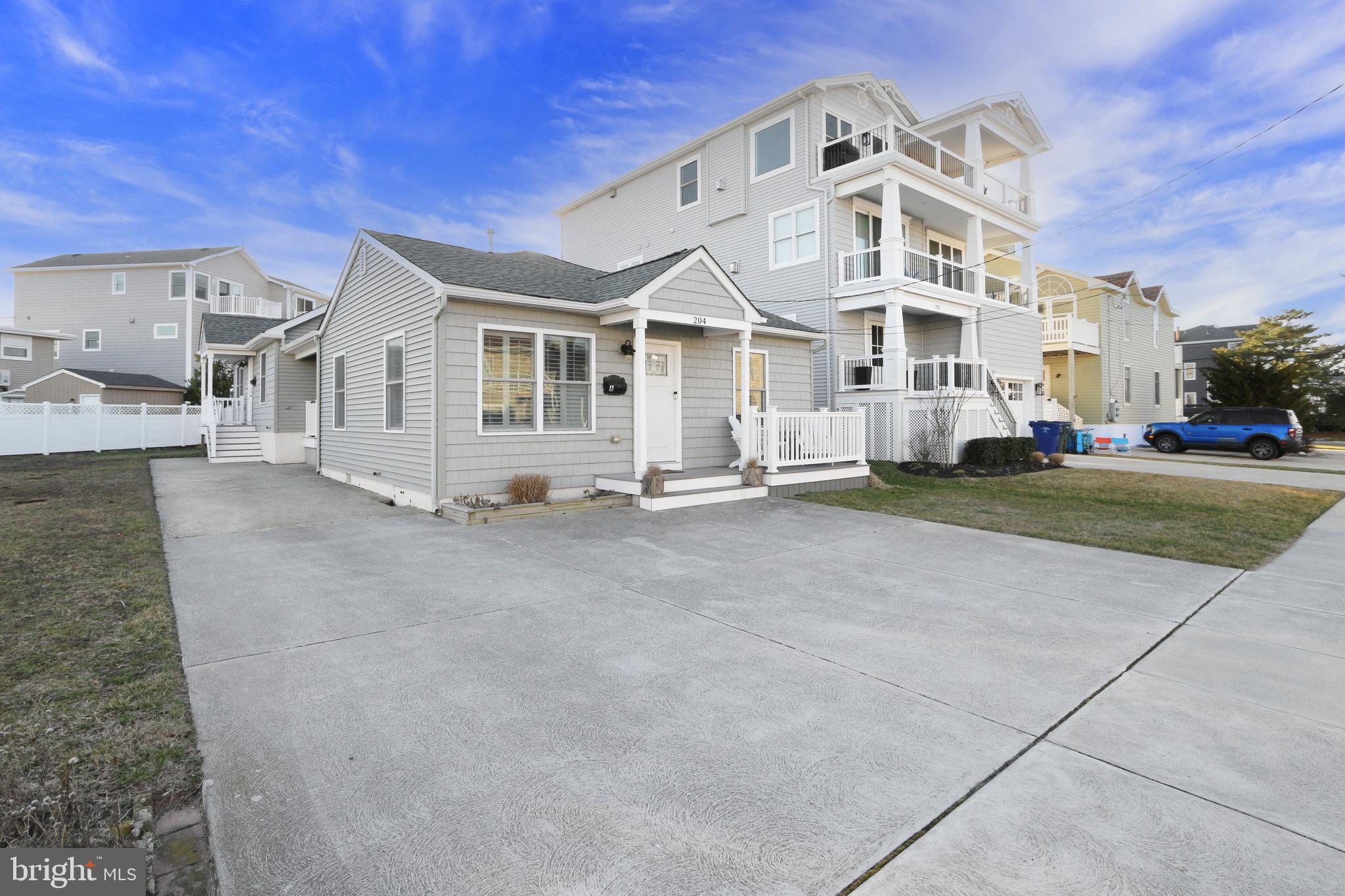 204 10th Street North Brigantine, NJ 08203 - Photo 82 of 88 a view of a white house with a big yard and large trees