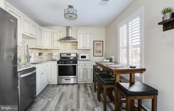 a kitchen with a stove and a refrigerator