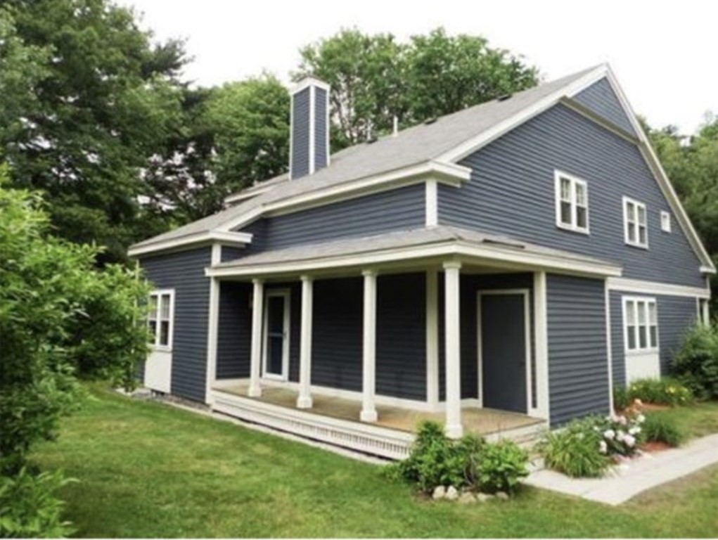 12 N Commons, Unit L Lincoln, MA 01773 - Photo 1 of 25 front view of a house with a yard
