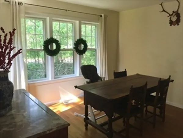 a view of a dining room with furniture and a window