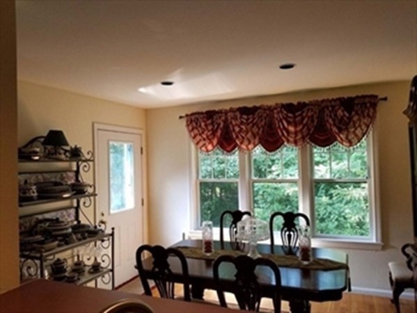 12 N Commons, Unit L Lincoln, MA 01773 - Photo 12 of 25 a view of a dining room with furniture window and outside view