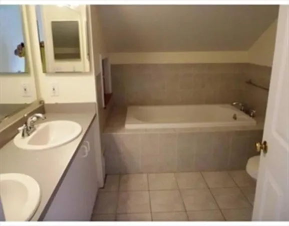a bathroom with a sink a toilet and bathtub