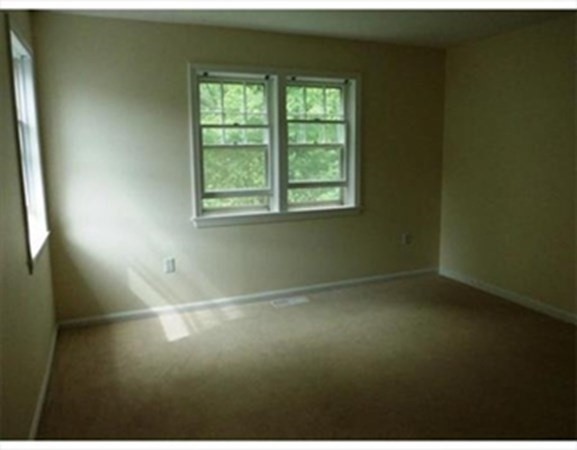 12 N Commons, Unit L Lincoln, MA 01773 - Photo 20 of 25 an empty room with a window