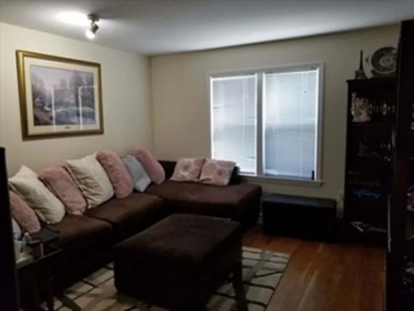 a living room with furniture and two window