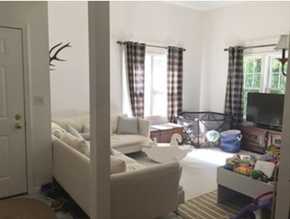 12 N Commons, Unit L Lincoln, MA 01773 - Photo 3 of 25 a living room with furniture and a flat screen tv