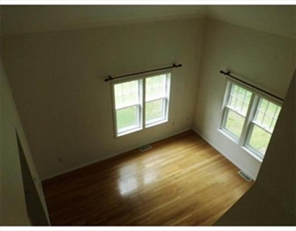 12 N Commons, Unit L Lincoln, MA 01773 - Photo 7 of 25 wooden floor in an empty room with a window