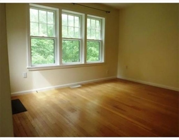 12 N Commons, Unit L Lincoln, MA 01773 - Photo 8 of 25 wooden floor in an empty room with a window
