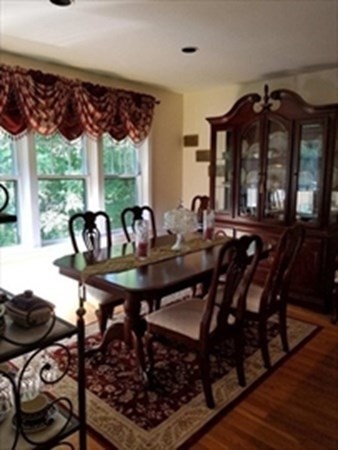 12 N Commons, Unit L Lincoln, MA 01773 - Photo 9 of 25 a view of a dining room with furniture window and outside view