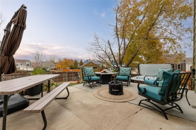 a view of a patio with table and chairs