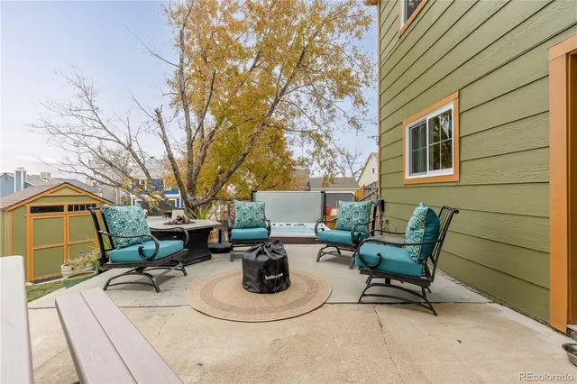 a view of a patio with table and chairs and potted plants